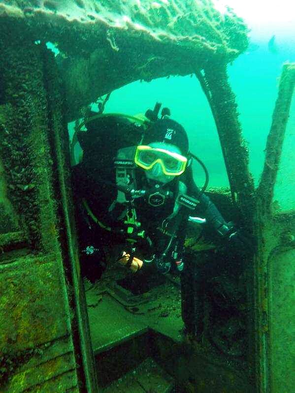 A diver inside a wreck's cabin